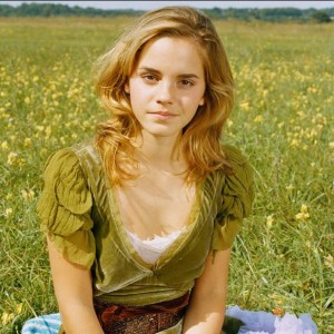 Emma Watson poses for the camera in a beautiful meadow.